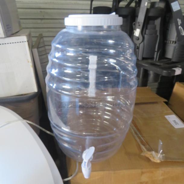 Clear plastic beverage dispenser with white lid and spigot. Appears to be in good condition. No visible brand markings.