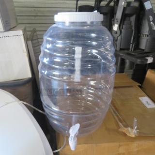 Clear plastic beverage dispenser with white lid and spigot. Appears to be in good condition. No visible brand markings.
