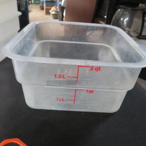 2 Quart clear food storage container with red measurements up to 2 quarts and 1.5 liters. Appears in good condition.