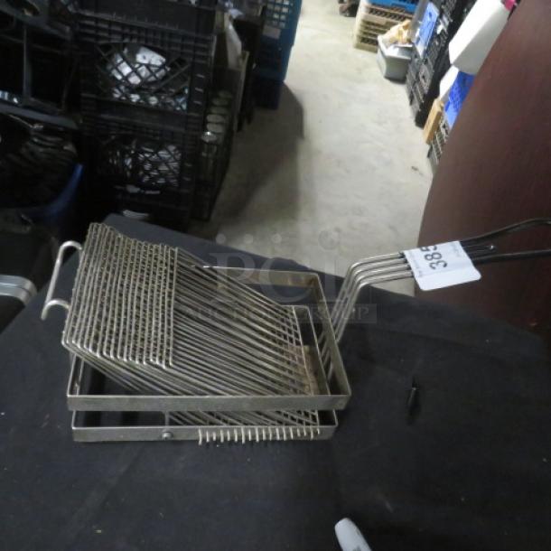 Stainless steel deep fry basket with wire mesh design, dual handles, and numbered auction tag. Good condition.