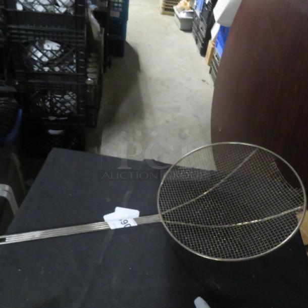 Alt text: Large metal deep fry scoop with mesh wire netting and long handle, in good condition. Tag labeled "59" attached to handle.