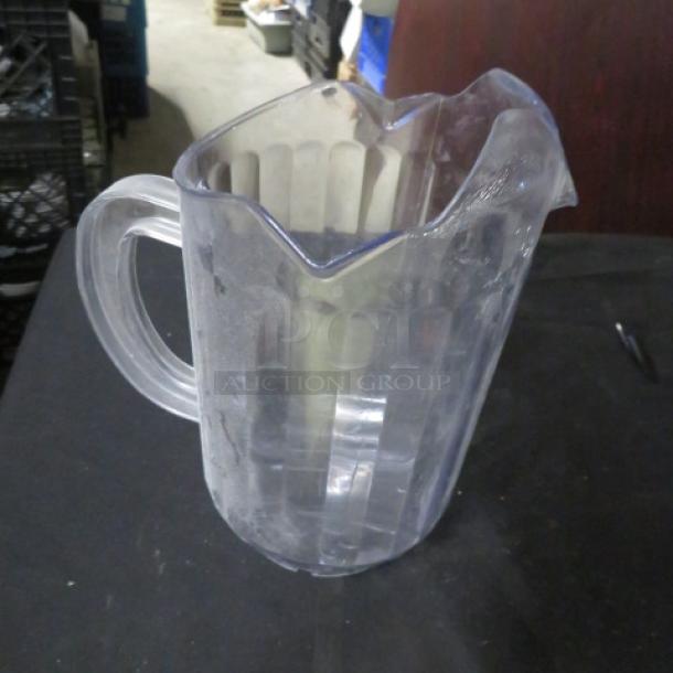 Clear dual pour pitcher with ridged design, visible scratches, used condition, model 8XBID.