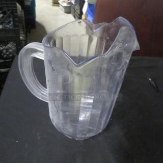 Clear dual pour pitcher with ridged design, visible scratches, used condition, model 8XBID.
