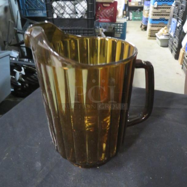 Amber glass decaf pitcher with ribbed design and handle, in good condition. Model 3XBID.