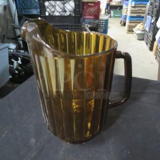 Amber glass decaf pitcher with ribbed design and handle, in good condition. Model 3XBID.