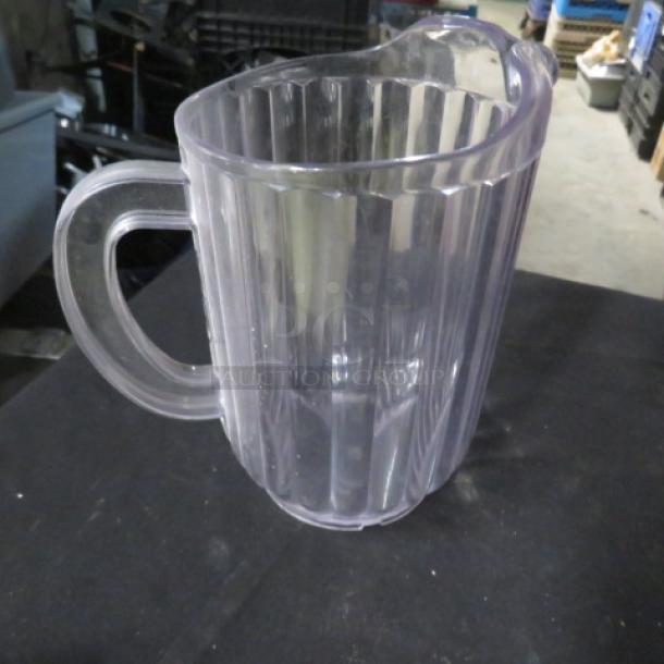 Clear poly pitcher with ribbed design and sturdy handle. Model 9XBID, in good condition. No visible markings or labels.