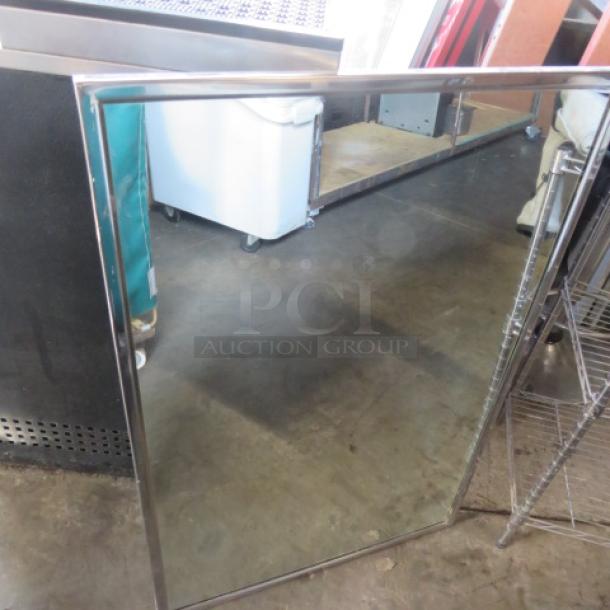 24x36 stainless steel framed mirror, excellent condition, reflective surface, durable construction.
