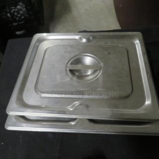Stainless steel 1/2 size hotel lid, 2XBID, with handle. Used condition, minor surface wear visible.