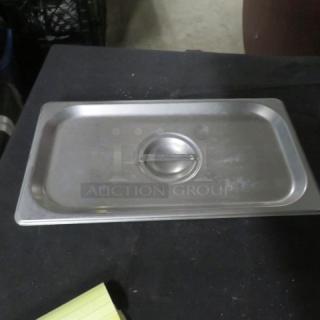 Stainless steel 1/3 size hotel lid, model 7XBID, with handle. Lightly used, shows minor surface wear.