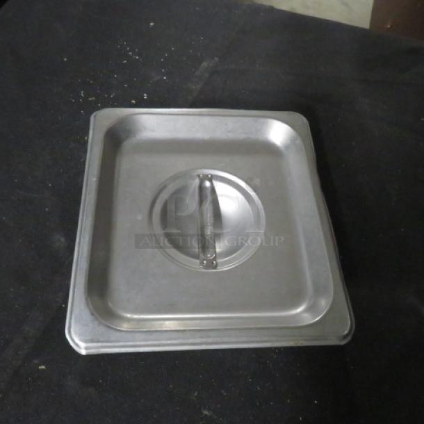 1/6 Size Hotel Lid, stainless steel, features handle with model 8XBID. Good condition, slight wear visible.