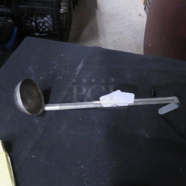 4oz stainless steel ladle with long handle, in good condition. Visible marking "5XBID" on tag.
