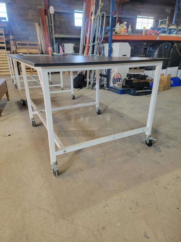 Formaspace Industrial Mobile Workbench, 8’x4’, black tabletop, steel frame, locking casters, for heavy-duty use.