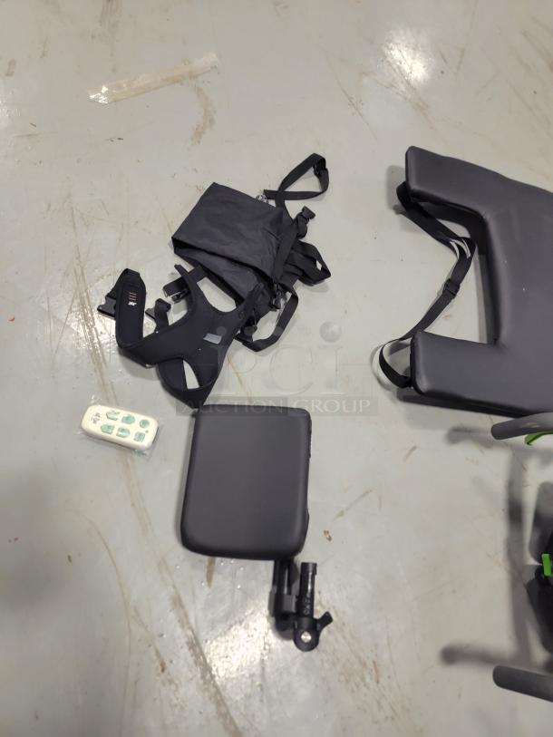 Quickie IRIS wheelchair components including JAY backrest, pressure cushion, and remote on a gray surface.
