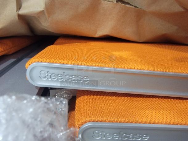 Steelcase privacy screens with orange acoustic fabric and aluminum mounting rail. Tackable surface, new condition.