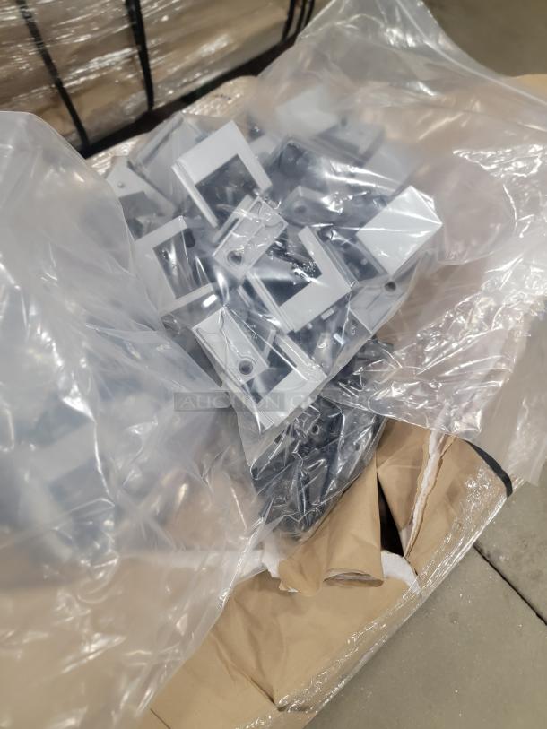 Bulk lot of Steelcase mounting brackets for privacy screens, packaged in a plastic bag, ready for installation.
