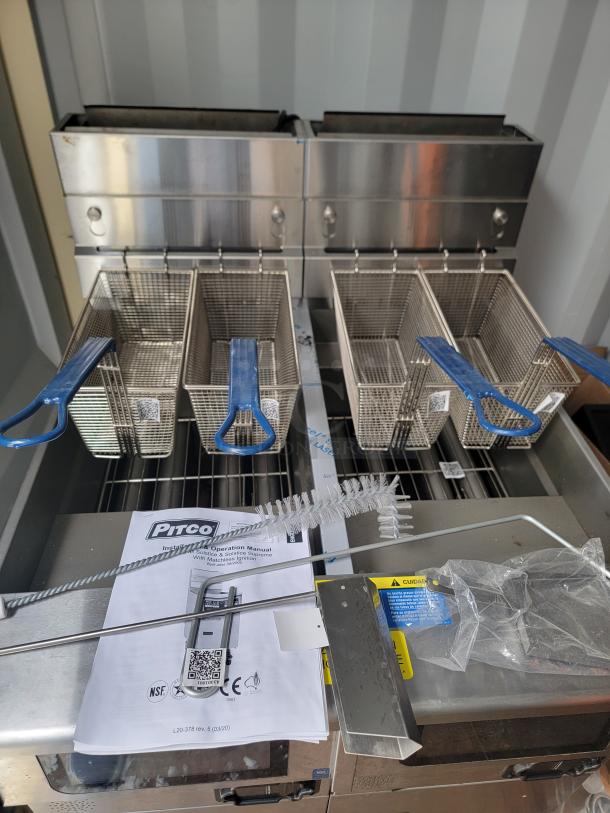 Brand new Pitco Ultrafryer UG14 dual-vat fryer with self-filtering system, touchscreen controls. Includes baskets, manuals, and accessories.