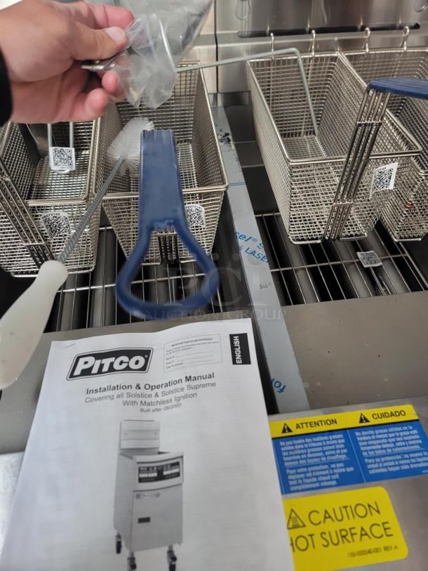 Brand new Pitco Ultrafryer UG14 dual vat fryer, featuring baskets, cleaning tools, manual, and factory tags. Never used.