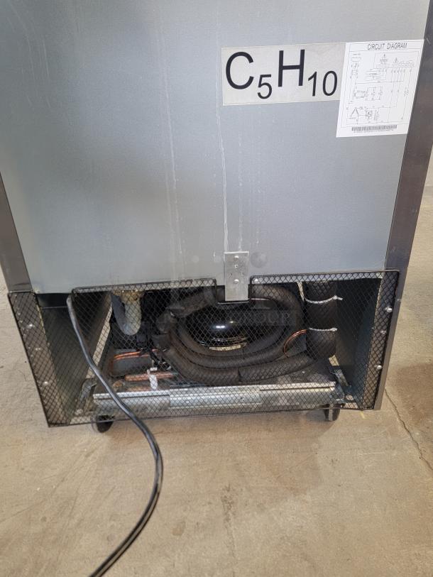 Back view of North American Restaurant Equipment model A1GDC-GR glass door refrigerator, showing casters and circuitry label.