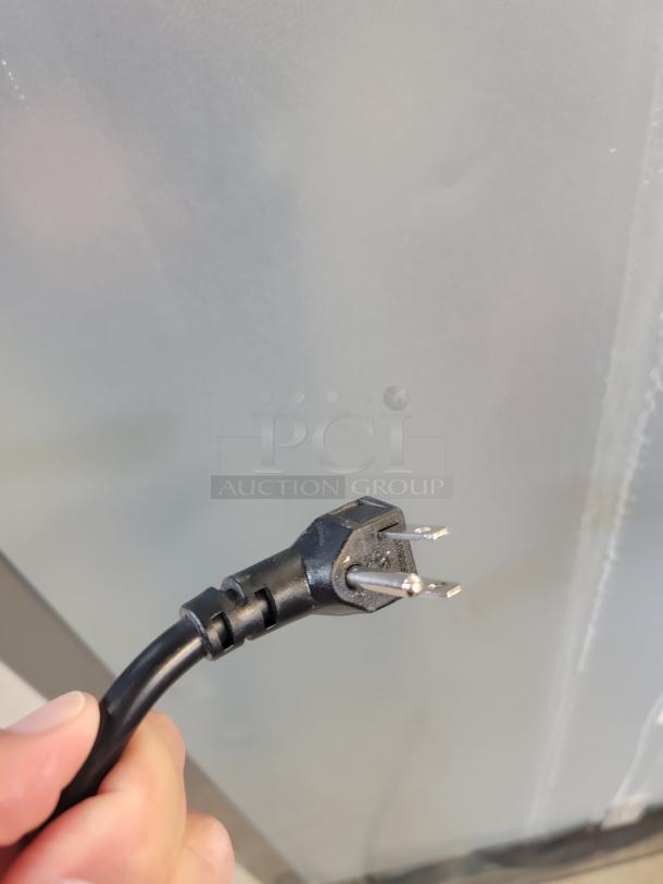 Close-up of a power cord for a North American Restaurant Equipment A1GDC-GR glass door refrigerator.