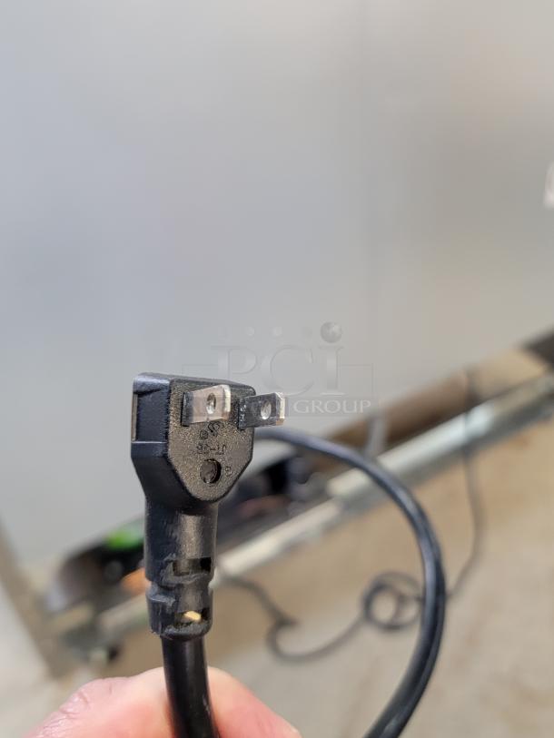 Close-up of power plug for 2021 North American Restaurant Equipment A2GDF-GR freezer, showing standard US prongs.