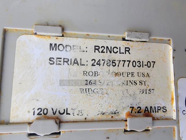 A weathered label stating "Model: R2NCLR, Serial: 24785777031-07, ROBB COUPE USA, 120 Volts, 7.2 Amps" on a gray surface.