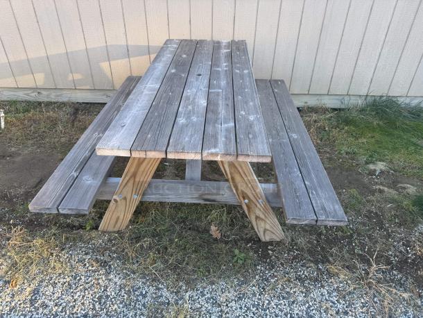 Heavy-duty 8' picnic table, A-frame design, natural patina, extremely sturdy, ideal for gatherings or BBQs.