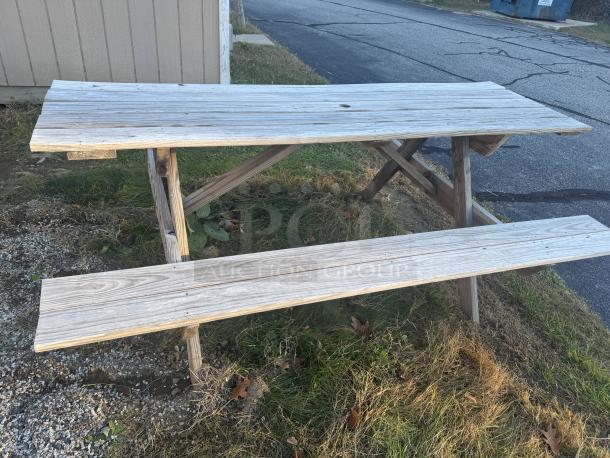 6-foot wooden picnic table with A-frame design, natural patina, very sturdy, suitable for gatherings, DIY staining potential.