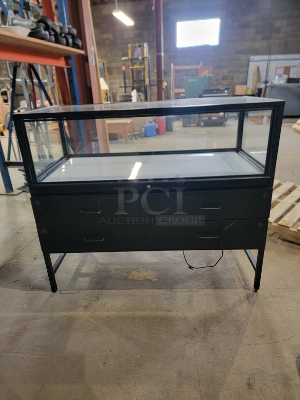 Dawson Jones lighted display showcase with secure locking system, four storage drawers, sleek black design, ideal for retail.