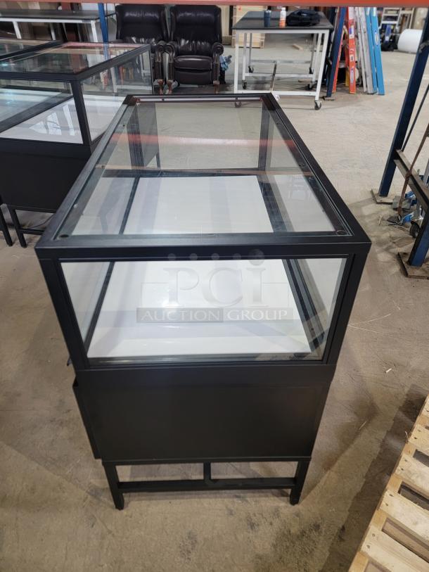 Dawson Jones lighted showcase, professional-grade, secure locking, four storage drawers, sleek design, excellent condition.