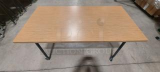 Steelcase flip-top training table with wood laminate top, model THWFRL3060NA2K6S4K. Features locking casters and collapsible design.