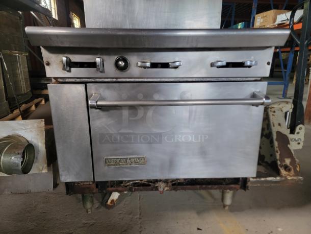 American Range 36" 6-Burner Gas Range with Oven, pre-owned, includes ventilation parts, metal finish, visible brand label.