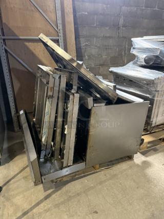 730lb pallet of stainless steel scrap, featuring industrial-grade components, panels, and shelving units, stacked for transport.