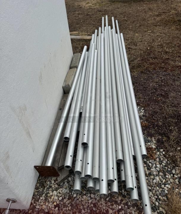 Premium West Coast Frame Tent components, including sturdy aluminum poles, part of a 20'x40' commercial tent system by Tent and Table.