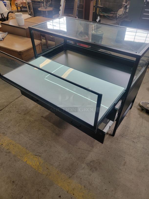 Dawson Jones lighted showcase with locking system and four magnetic lock drawers, ideal for retail display. Sleek design.