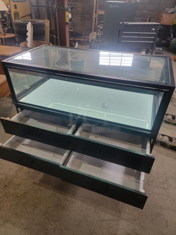 Dawson Jones lighted showcase with secure locking system, four magnetic-lock drawers. Ideal for retail displays. Sleek, modern design.