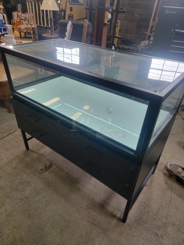 Dawson Jones lighted showcase with secure locking, four magnetic-lock drawers, sleek design for retail or restaurant display.