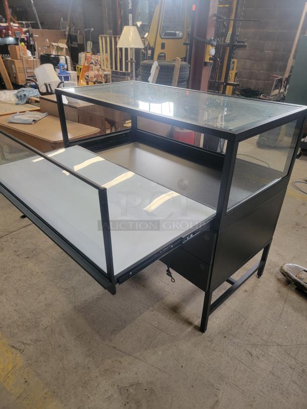 Dawson Jones lighted showcase with secure locking, four magnetic drawers, and sleek design for retail display and security.