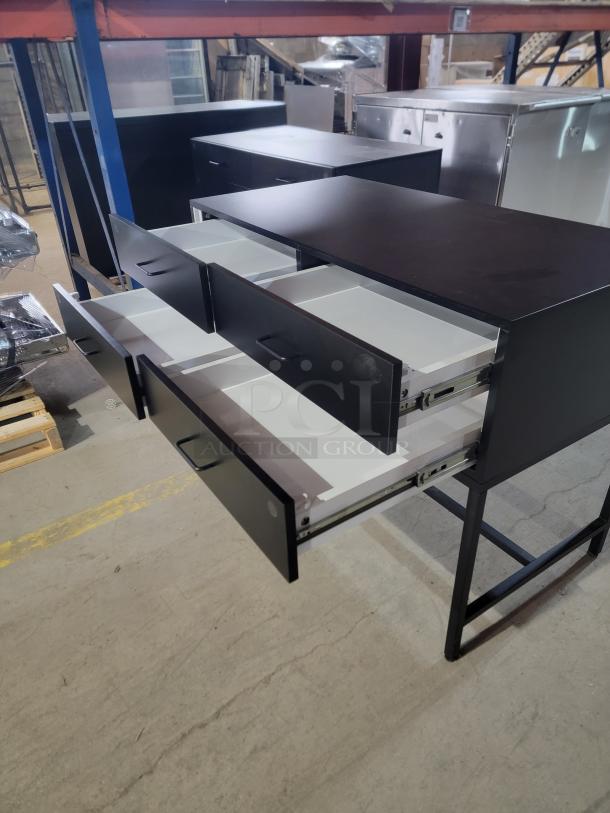 InterMetro magnetic locking 4-drawer industrial console in matte black. Features a 4'x2' surface, heavy-duty steel base, and magnetic key security.