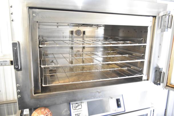 Duke TSC3-6/18 commercial oven proofer on casters, 208V, 3-phase, stainless steel, interior racks, Duke label visible.