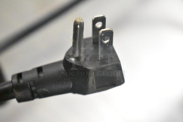 Close-up of a standard three-prong power plug, suitable for the Beverage Air MT53-1-SD cooler.