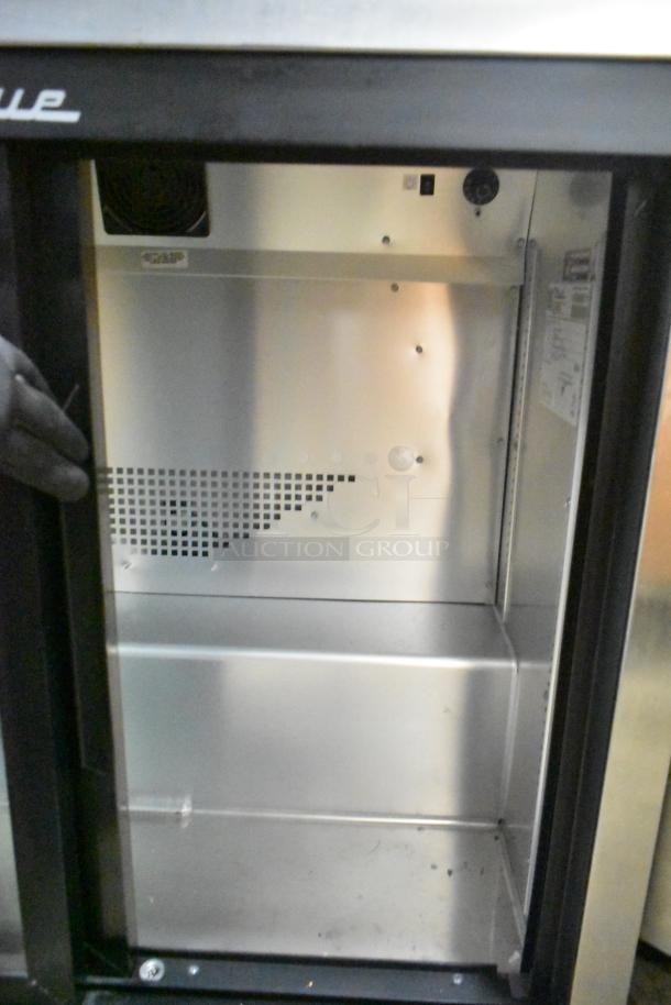 2021 True TSD-09G-HC-LD commercial 2-door back bar cooler, silver interior, 115 volts, model label visible.