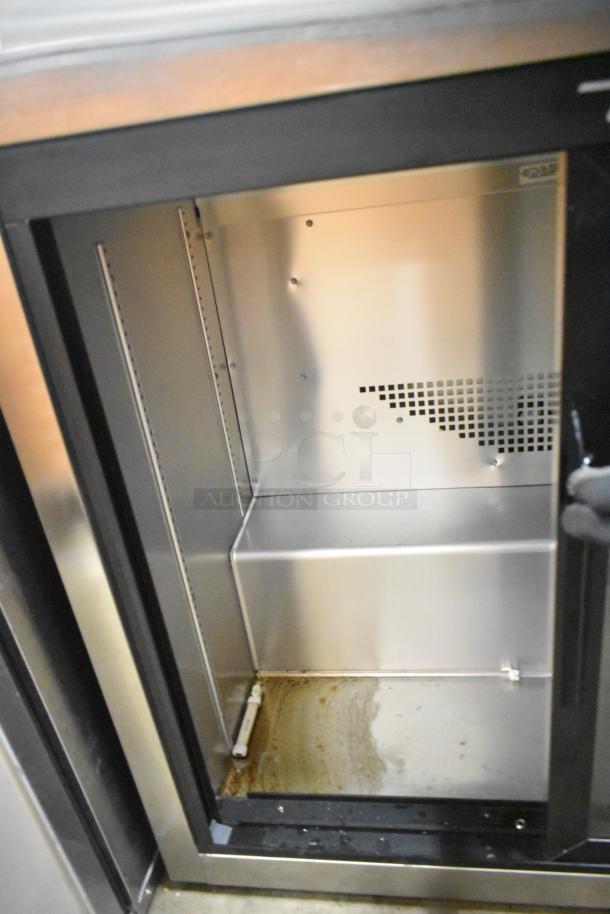 2021 True TSD-09G-HC-LD 2 Door Back Bar Cooler, commercial-grade, shows interior with some wear. 115 volts, 1 phase.