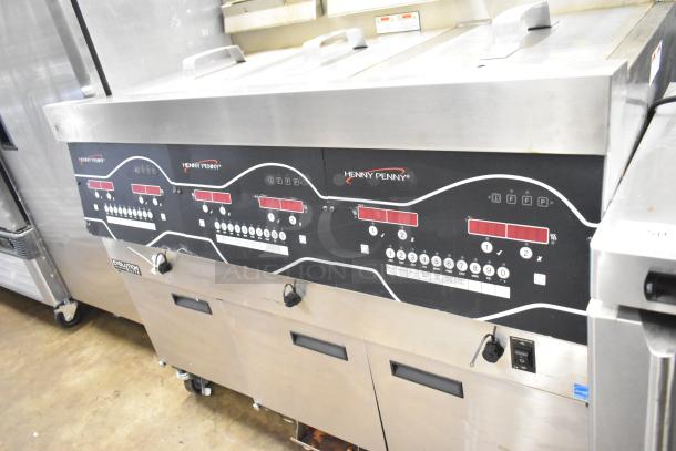 Henny Penny EEG-253 3-bay propane gas fryer, 225,000 BTU, on commercial casters. Clean, stainless steel finish, prominent controls.