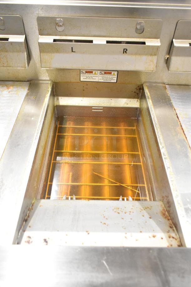 Henny Penny EEG-253 gas fryer, 3 bays on commercial casters, 225,000 BTU. Visible grease and use wear in the cooking area.