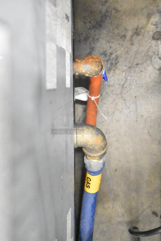 Henny Penny EEG-253 fryer gas connection with blue hose labeled "GAS," visible wear on metal fittings.