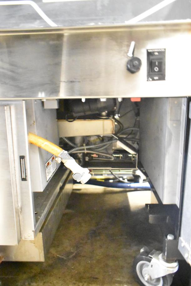 Henny Penny EEG-253 3 Bay Propane Gas Fryer on casters, 225,000 BTU, commercial use, visible control panel and connections.