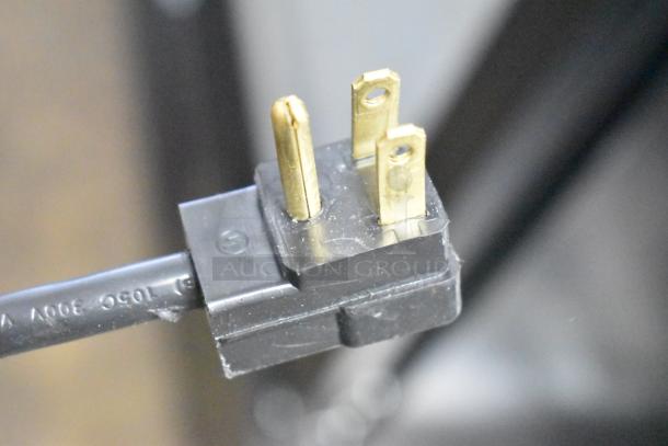 Close-up of a 3-prong plug for Beverage Air MMF35HC-1-B Commercial Freezer, 115V, 1 Phase; details cable condition.