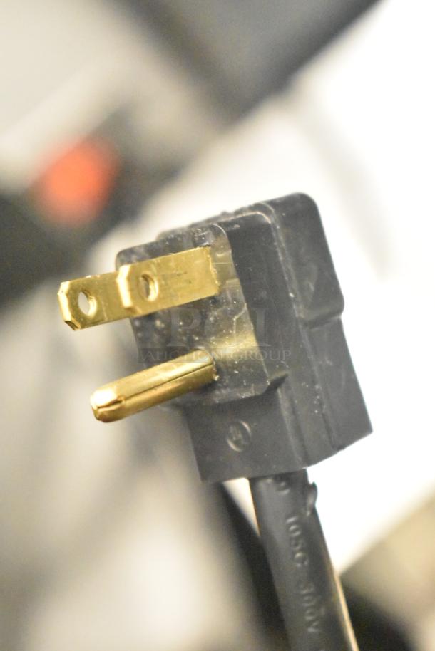 Close-up of a three-prong power plug for a Beverage Air MMF35HC-1-B freezer merchandiser, 115V, 1 phase.
