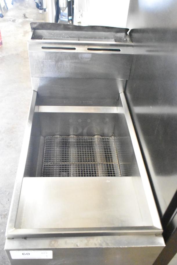 "Commercial floor style gas-powered deep fat fryer in stainless steel, featuring a wire basket and visible control panel, good condition."