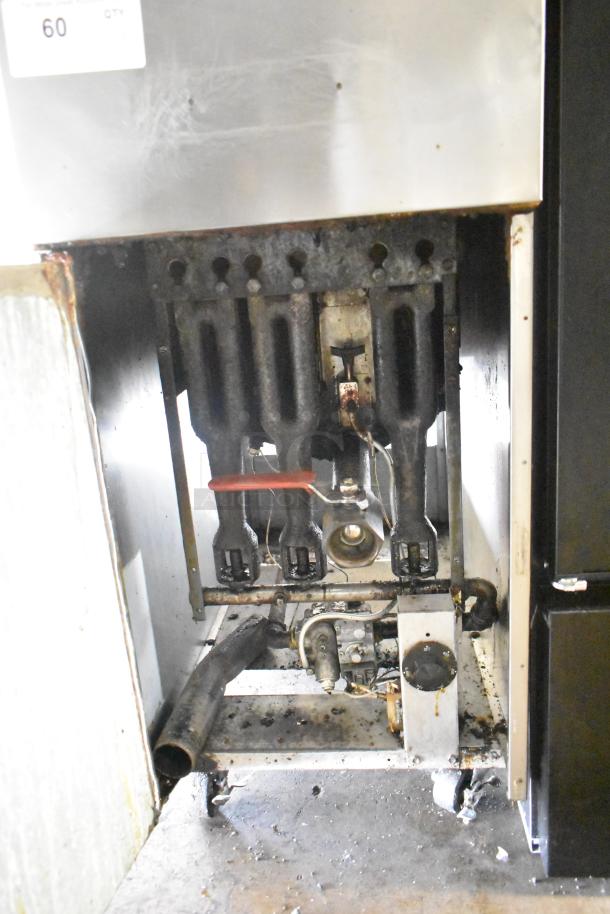 Commercial floor-style gas-powered deep fat fryer, visible internal components, showing signs of use, suitable for large kitchens.